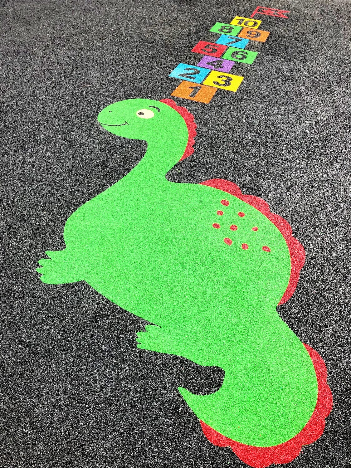 Dinosaur playground markings with a hop-scotch board
