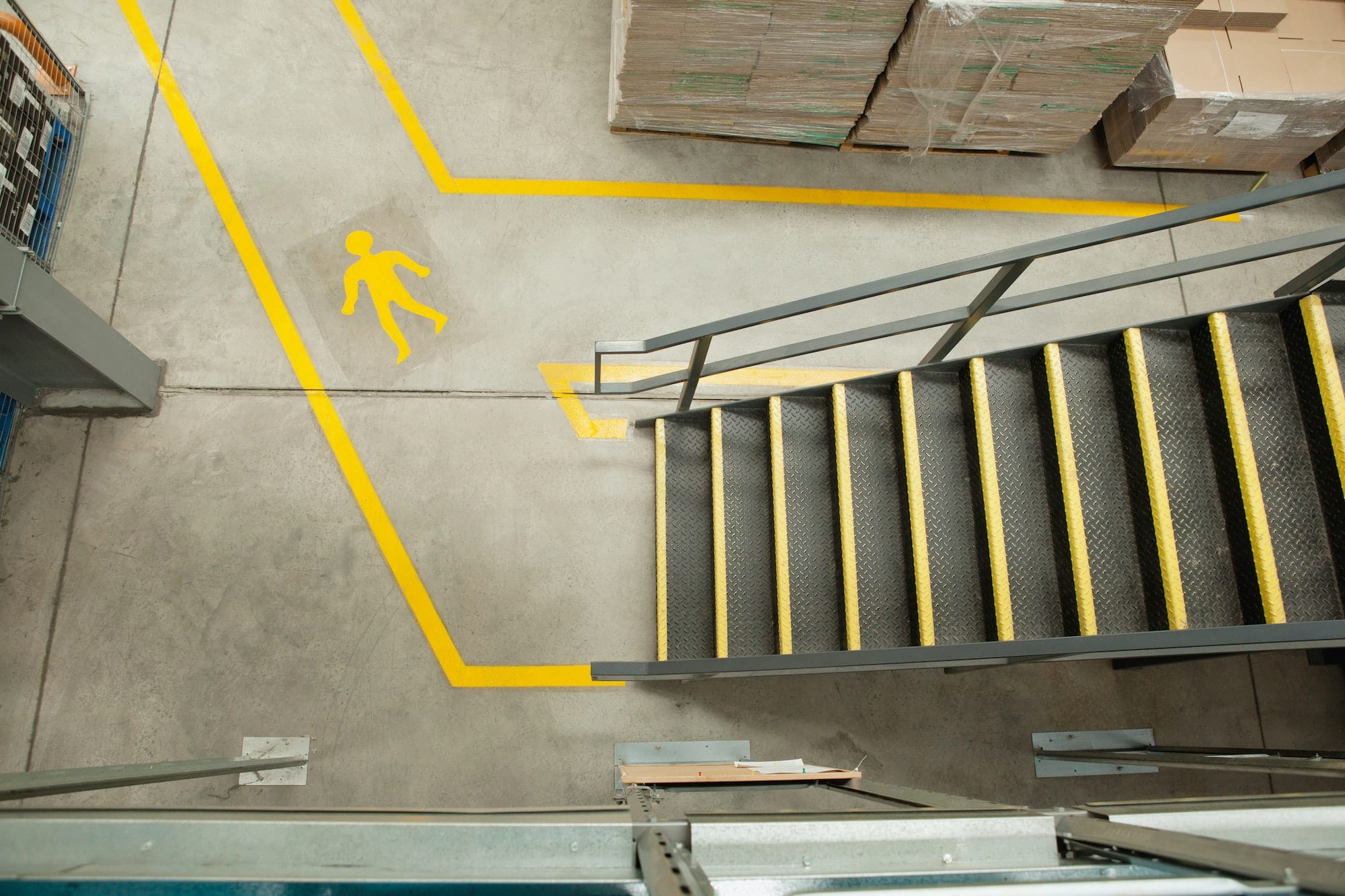 Steps and yellow lines in warehouse, elevated view